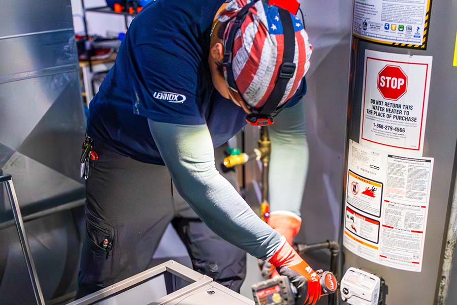 Professional HVAC installer focused on maintenance work in a mechanical room