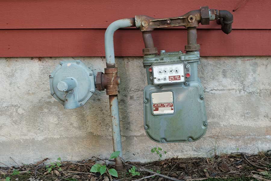 Outdoor natural gas meter installed on the side of a house
