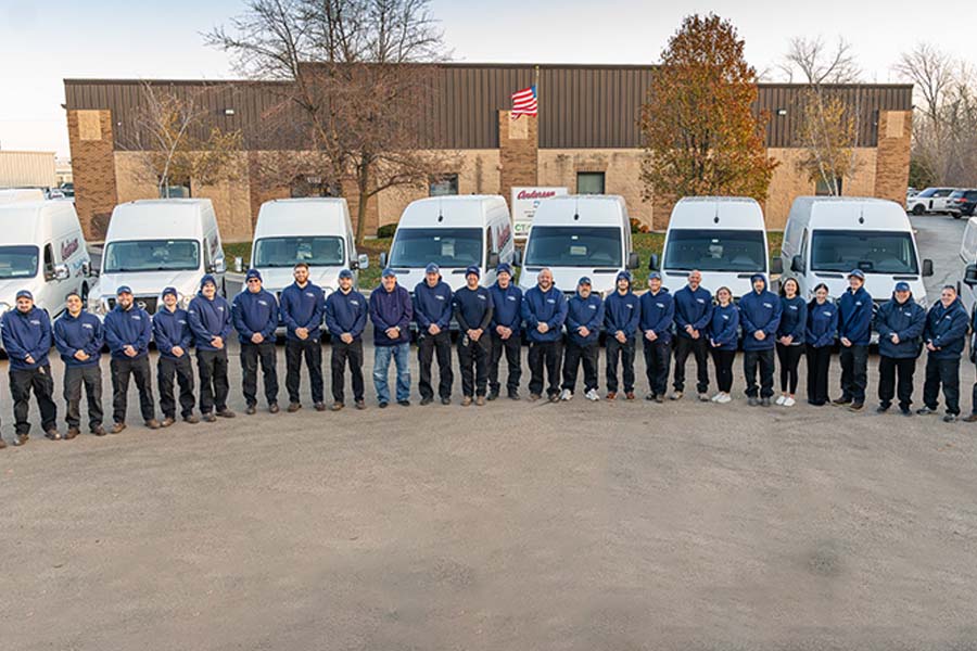 Andersen team in front of service vans
