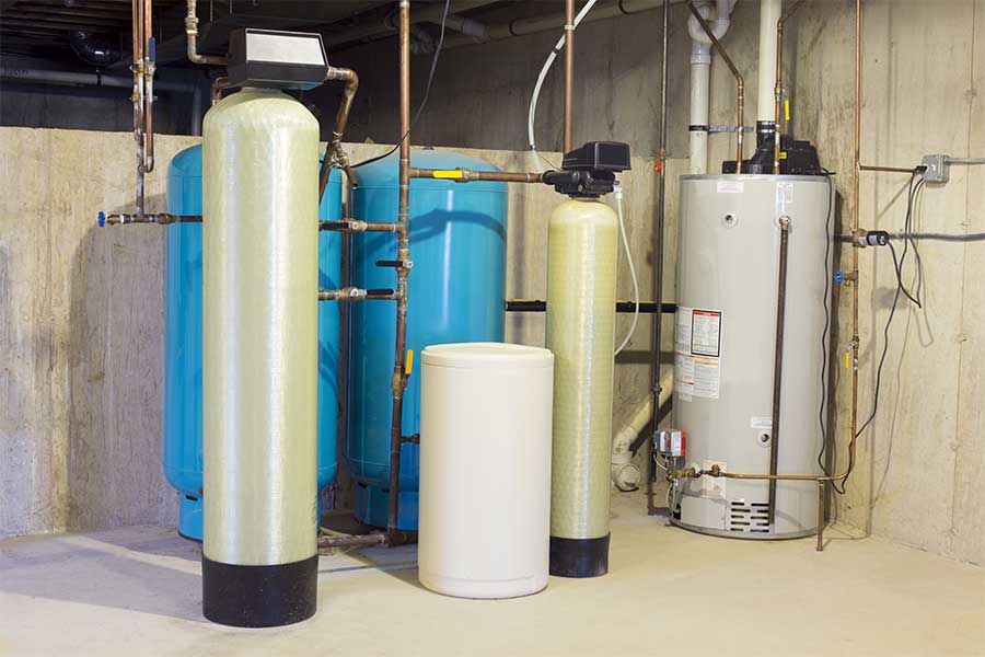 Basement water treatment system with softeners and a water heater.