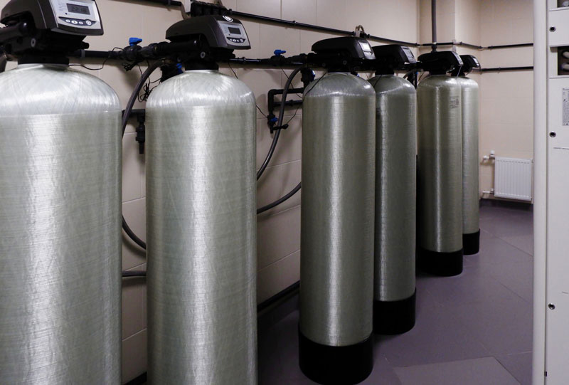 Industrial water softening system with multiple filtration tanks.