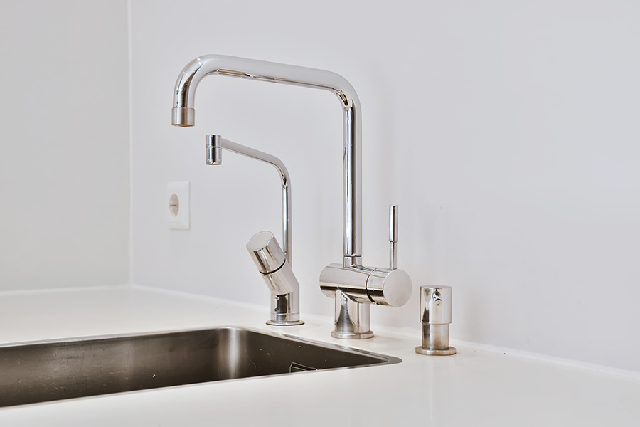 Modern chrome faucets above sink