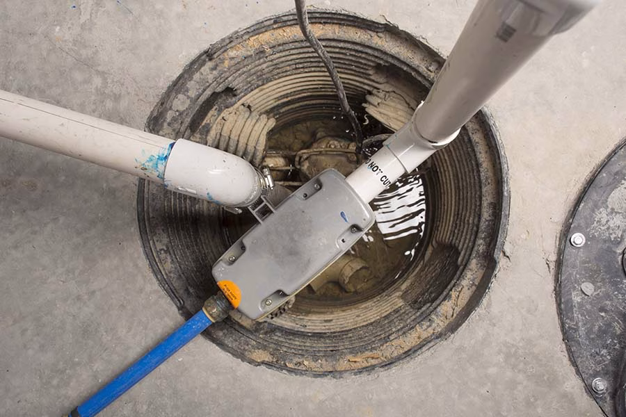 Sump pump system with water discharge pipes