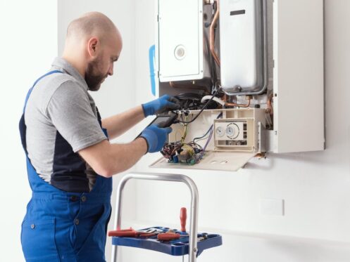 Technician tinkering with a heating system